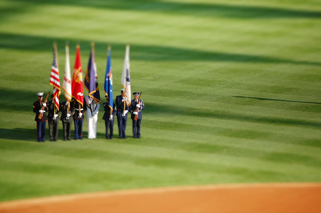 Holding flags during the national anthem tilt Shift Photography